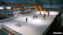 FILE - Members of Kenya's ice hockey team skate during a practice session in East Africa's only ice rink, in Nairobi, Kenya, Jan. 24, 2018.