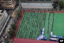 An aerial view of people lining up to get tested for the coronavirus at a makeshift testing site in Hong Kong, Feb. 9, 2022.