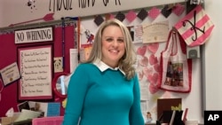 Katie Peters, an English teacher at Whitmer High School, poses in her classroom on Feb. 7, 2022, in Toledo, Ohio. (AP Photo/John Seewer)