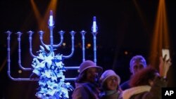 People take pictures in front of a Menorah during the Jewish festival of Hannukah, in Istanbul, Dec, 24, 2016. Hanukkah, known as the Jewish Festival of Lights, is celebrated for eight days. 