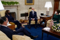 President Joe Biden and Vice President Kamala Harris meets with Sen. Mitt Romney, R-Utah, Sen. Susan Collins, R-Maine, and others to discuss a coronavirus relief package, in the Oval Office of the White House, Feb. 1, 2021, in Washington.
