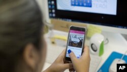 Luciana Santos shows the photo of puddles she sent via the app called “Sem Dengue,” or “Without Dengue,” in Niteroi, Brazil, March 8, 2016. 