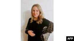 This undated handout photo provided courtesy of Kate Cox, shows Cox standing for a photo in Dallas-Fort Worth, Texas.