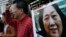 FILE - Anti-Beijing protesters hold picture of veteran Chinese journalist Gao Yu during a rally outside Chinese central government's liaison office in Hong Kong.