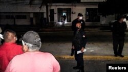 Police officers guard the perimeter of a scene where Heber Lopez, an independent journalist who ran NoticiasWeb, was shot and killed at his recording studio, in Salina Cruz, in Oaxaca state, Mexico Feb. 10, 2022. 