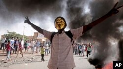 FILE - A man flashes the victory sign during a protest to denounce the October 2021 military coup, in Khartoum, Sudan, Jan. 9, 2022. 