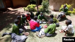 Priscilla Sitienei chats with her classmates after a lesson, January 25, 2022. REUTERS/Monicah Mwang