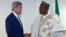 U.S. Secretary of State John Kerry, left, talks with newly inaugurated Nigerian President Muhammadu Buhari, before the start of a formal meeting in Abuja, Nigeria, May 29, 2015. 