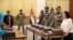 The leader of Sudan's transitional council looks on as military and civilian members of Sudan's new ruling body, the Sovereign Council, are sworn in at the presidential palace in Khartoum, Sudan, Aug. 21, 2019. 