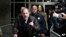 FILE - Harvey Weinstein gestures as he walks by reporters as he leaves a Manhattan courtroom after attending jury selection for his trial on rape and sexual assault charges, Jan. 17, 2020 in New York.