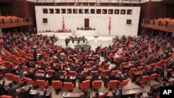 Members of Turkey's parliament vote to send Turkish troops to Libya to help the U.N.-supported government in Tripoli battle forces loyal to a rival administration in eastern Libya that is seeking to capture the capital, in Ankara, Turkey, Jan. 2, 2020.