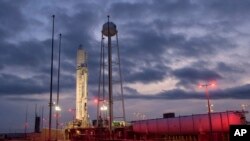 This Tuesday, Oct. 29, 2019 photo made available by NASA shows the Northrop Grumman Antares rocket a few hours after arriving at its launch pad at NASA's Wallops Flight Facility in Virginia. 