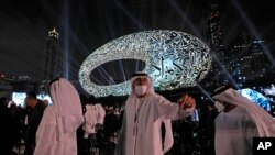 People leave after the opening ceremony of the Museum of the Future, an exhibition space for innovative and futuristic ideas, in Dubai, United Arab Emirates, Feb. 22, 2022.