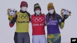 From left silver medalist Canada's Marielle Thompson, gold medalist Sweden's Sandra Naeslund and bronze medalist Germany's Daniela Maier celebrate after the women's skicross finals at the 2022 Winter Olympics, Feb. 17, 2022, in Zhangjiakou, China.