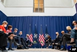 U.S. Vice President Kamala Harris, center-right, meets with NATO Secretary General Jens Stoltenberg, center-left, during the Munich Security Conference, in Munich, Germany, Feb. 18, 2022.