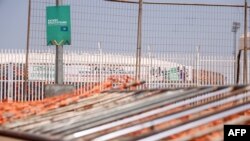 FILE - Barriers are seen knocked to the ground at the entrance of Olembe stadium in Yaounde, Cameroon, Jan. 25, 2022, following a stampede a day earlier ahead of an Africa Football Cup of Nations match.