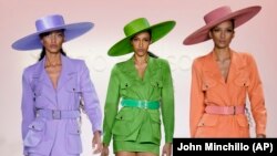 Fashion from Sergio Hudson's fall/winter 2022 collection is modeled during Fashion Week, Sunday, Feb. 13, 2022, in New York. (AP Photo/John Minchillo)