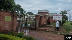 FILE - A medic walks past gates at Kamuzu Central Hospital in Lilongwe, Malawi, Jan. 18, 2021. A polio case in the country, which was declared polio-free in 2005, has prompted the declaration of a national health emergency. 