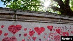 Dedications to coronavirus disease victims are seen written on the National Covid Memorial Wall in London, Britain, May 27, 2021. 