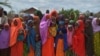 FILE - Refugees gather to watch the arrival of United Nations High Commissioner for Refugees Antonio Guterres at IFO-2 complex of the sprawling Dadaab refugee camp, May 8, 2015.