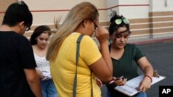 FILE - Activists Maria Nieto, right, and Alma Romo, second from left, register people to vote in the U.S. midterm election in November, in Las Vegas, Nevada, Aug. 15, 2018.