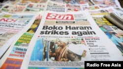 A newspaper with its frontpage headline on an abduction of women from a village in northeast Nigeria is displayed at a vendor's stand along a road in Ikoyi district in Lagos, Nigeria, June 10, 2014.