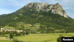 The village and Peak of Bugarach, the highest point of the Corbieres massif, in southwestern France, is seen June 24, 2011. 