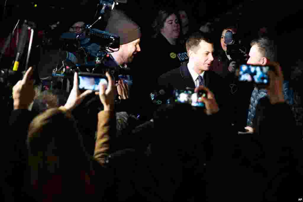 Democratic presidential candidate former South Bend, Ind., Mayor Pete Buttigieg meets with people outside a polling place in Manchester.
