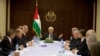 Palestinian President Mahmoud Abbas (C) meets with ministers of the unity government, in the West Bank city of Ramallah June 2, 2014. Abbas swore in a Palestinian unity government on Monday under a reconciliation deal with Hamas.