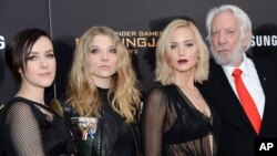 Actors, from left, Jena Malone, Natalie Dormer, Jennifer Lawrence and Donald Sutherland attend a special screening of "The Hunger Games: Mockingjay Part 2," Nov. 18, 2015, in New York. 