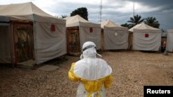 FILE PHOTO: A health worker wearing Ebola protection gear, prepares to enter the Biosecure Emergency Care Unit at the Alliance for International Medical Action ebola treatment center in Beni, DRC, March 30, 2019. 