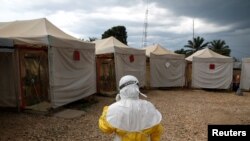 FILE - A health worker wearing Ebola protection gear prepares to enter the Biosecure Emergency Care Unit at an Ebola treatment center in Beni, Democratic Republic of Congo, March 30, 2019.