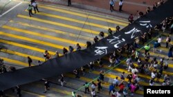 Occupy Central protesters march with 500-meter long black cloth, which they say symbolizes the loss of credibility in Beijing's refusal to allow true democracy in Hong Kong, Sept. 14, 2014.