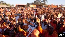 Supporters of Malawi's incumbent President cheer during her final campaign rally at Songani village on the outskirts of the city of Zomba, the former capital of Malawi, May 17, 2014.
