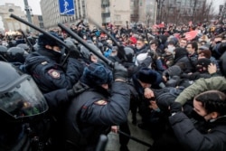 FILE - Law enforcement officers clash with protesters during a rally in support of jailed Russian opposition leader Alexey Navalny in Moscow, Russia, Jan. 23, 2021.