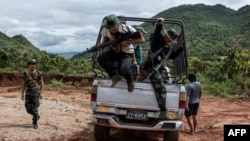 FILE - Members of the Karenni Nationalities Defence Force and Kareni Army at a checkpoint near Demoso, in Myanmar's eastern Kayah state, Oct. 19, 2021.