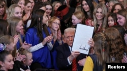 Дональд Трамп подписывает указ о запрете участия трансгендерных людей в спортивных соревнованиях среди женщин. Белый дом, 5 февраля 2025 года. REUTERS/Leah Millis.