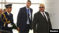 King Mohammed VI of Morocco (R) is escorted as he arrives at the 28th Ordinary Session of the Assembly of the Heads of State and the Government of the African Union in Ethiopia's capital Addis Ababa, Jan. 31, 2017. 