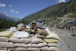 An Indian paramilitary soldiers on guard at a check post some 81 kilometers from Srinagar along a highway leading to Ladakh, where the Galwan Valley is located, on June 17, 2020.
