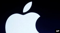FILE - The Apple logo is projected during an announcement in San Francisco.