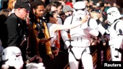 FILE - A fan takes a selfie with a Stormtrooper at the premiere for the movie "Solo: A Star Wars Story" in Los Angeles, California, U.S., May 10, 2018.