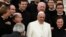 Pope Francis poses with a group of priests at the end his Wednesday general audience in Saint Peter's square at the Vatican Feb. 26, 2014.