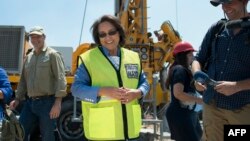 Cape Town City Mayor Patricia de Lille (C) talks to media at a site where the city council has ordered drilling into the aquifer to tap water, in Mitchells Plain, about 25km from the city center on Jan. 11, 2018 in Cape Town.