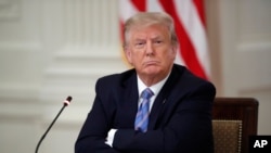 U.S. President Donald Trump listens during a "National Dialogue on Safely Reopening America's Schools," event in the East Room of the White House, July 7, 2020, in Washington. 
