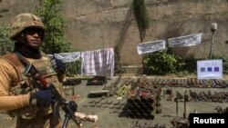 Pakistani soldier stands by ammunition seized during a military operation against Taliban militants, Miranshah, North Waziristan, July 9, 2014.