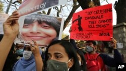 People hold placards demanding the release of Indian climate activist Disha Ravi, during a protest in Bengaluru, India, Feb.15 2021.