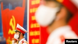 FILE - Vietnamese soldiers, wearing protective masks, stand guard at the National Convention Center, the venue for the 13th National Congress of the Communist Party of Vietnam during the coronavirus disease (COVID-19) outbreak in Hanoi, Vietnam, January 28, 2021. REUTERS/Kham 