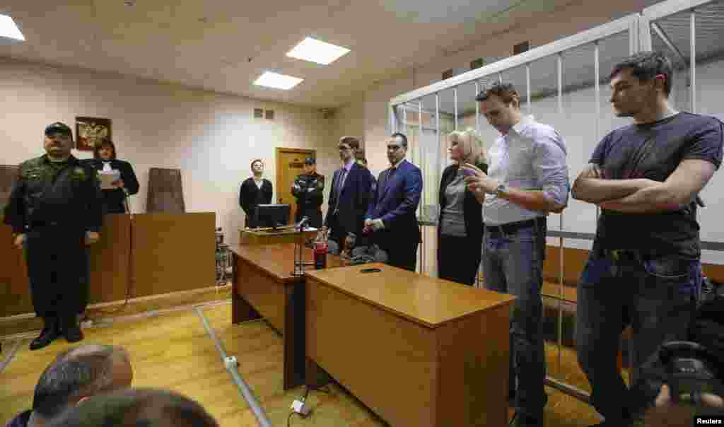 Russian opposition leader and anti-corruption blogger Alexei Navalny and his brother and co-defendant Oleg attend a court hearing in Moscow, Dec. 30, 2014.