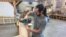 American College of the Building Arts sophomore Steven Fancsali sands a piece of wood for a workbench, in Charleston, S.C., Sept. 17, 2019. (J. Taboh/VOA News)