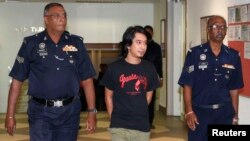 Aktivis mahasiswa Malaysia, Adam Adli, dikawal ketat oleh polisi menuju pengadilan di Kuala Lumpur (23/5). 